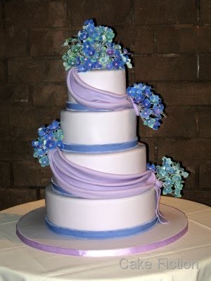 Our bride requested a violet colored four tier wedding cake wrapped around 