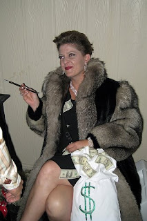 Halloween costume with woman dressed up as greedy rich person