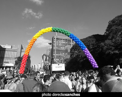rainbow flag made out of balloons at parade