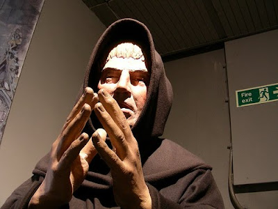 statue of evil priest praying
