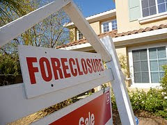 house with foreclosure sign