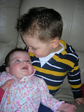 Little cousin Gage holding Audrey!! He loves the babies!