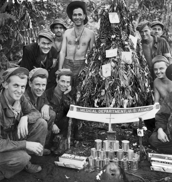 Buna, Papua, 1942. American soldiers at an advanced dressing station with a handmade Christmas tree decorated with surgical cotton wool and cigarette cartons.