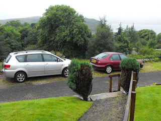 Two cars parked at the Manse
