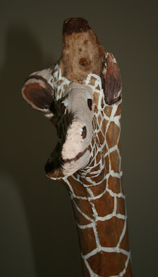 Funny painted giraffe driftwood