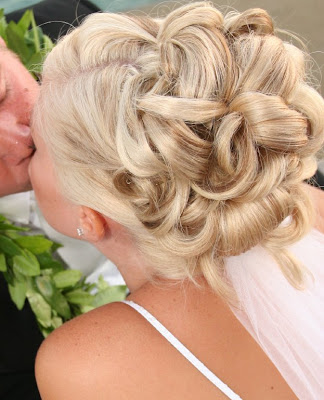 A bride will take time to consider many wedding hairstyles to make sure she 