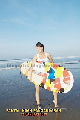 Farah Quinn surfing on the beach