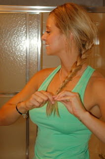 picture of girl looking in mirror with long blonde braid