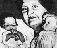 Oldest Mother Did Not Know Image: Joanna Du Plessis, 58, holds her baby Magda and one of her grandchildrens dolls. Mrs. Du Plessis had to borrow dolls clothing to dress the unexpected baby.