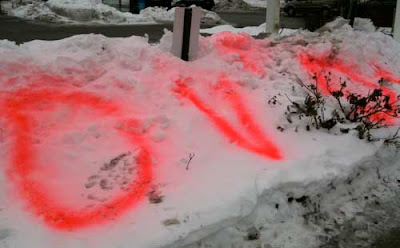 Red spray-painted word DVDs on a snowbank