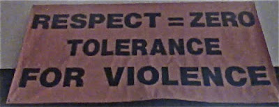 Ugly banner that reads Respect = Zero / Tolerance / for Violence