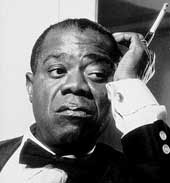 Louis Armstrong with cigarette in long holder, looking pensive