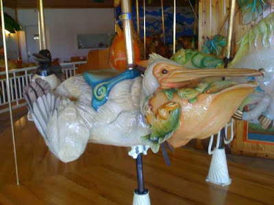Colorful carved pellican on carousel
