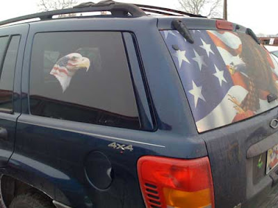 Side view of the Jeep, with another eagle-head with flag on the side window