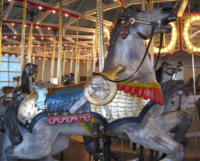 Carousel horse with a sword and shield on its side