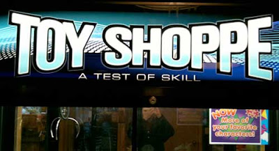 Lit sign reading Toy Shoppe, A Game of Skill in sans serif type