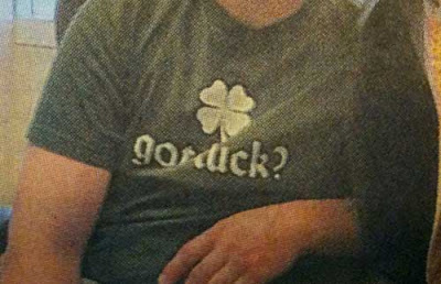 Closeup of boy's t-shirt, which looks like it says Got dick? but probably says Got luck?