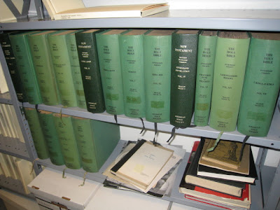 Library bookshelves with many volumes of a Braille Bible