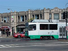 Color photograph of Boston T (electric train), Cleveland Circle line, crossing the Coolidge Corner intersection in Brookline, Mass. Photograph by Anna Cook, 2009.