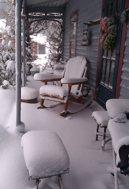 A snow covered porch from a house in the Central Taconics during the day after Christmas blizzard of 2010