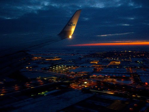 Flying over Amsterdam at sunrise.