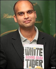 Aravind Adiga holding his Booker-prize-winner novel The White Tiger