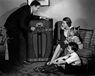 vintage photo of family gathering around radio