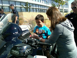 Mom helping Dj on the Police motorcycle