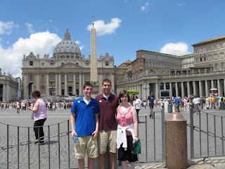 Our kids in Rome posing in front of old buildings 