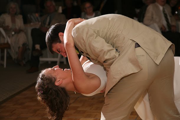 John dipping Ellie during their first dance at their wedding at the Harbor Lights room
