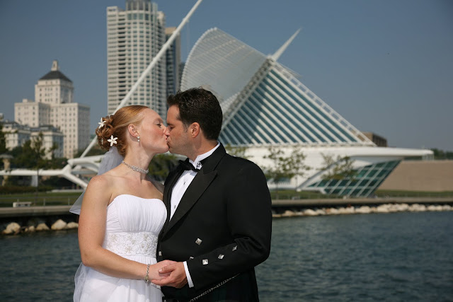 Bridal couple kissing before wedding in front of Calatrava by Milwaukee lakefront