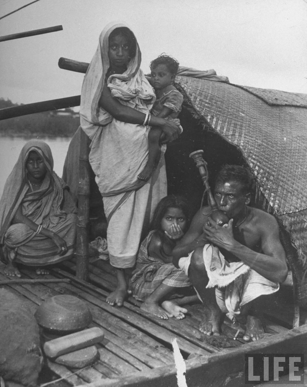 Indian family on river boat where they live - 1946