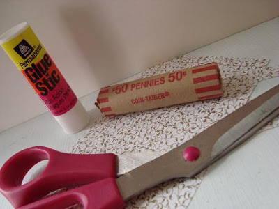 Coin roll, glue-stick, scissors, and patterned paper