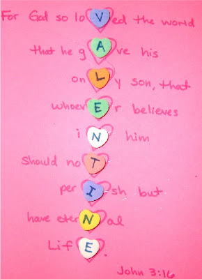 John 3:16 on paper with candy hearts attatched