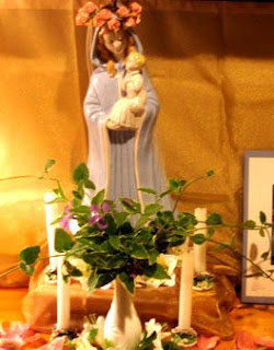 Mary and baby Jesus Statuette surrounded by candles