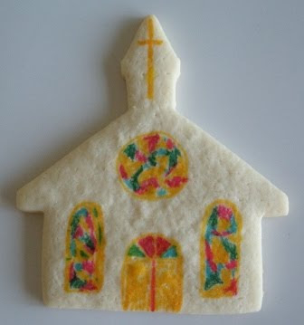 Sugar cookie in the shape of a church with colorful windows