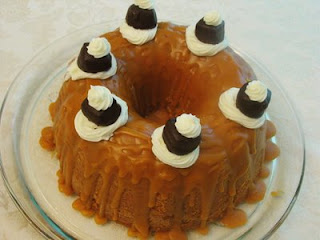 Caramel bundt cake with chocolates and whipped cream on top