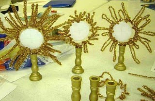 Monsterances made out of gold pipe cleaner and gold painted candlestick holders