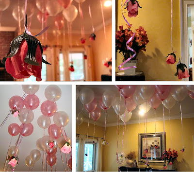 Pink and white balloons on the ceiling with fake roses hanging from them