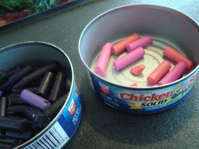 Pink and purple crayons in tuna cans