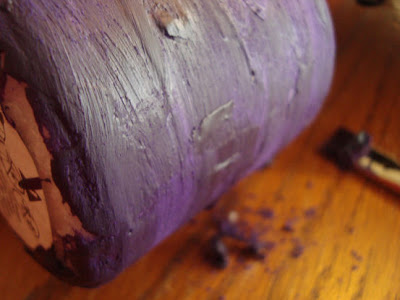 Pillar candle coated in purple crayon wax