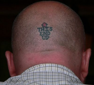 tatto-on-head-saying-this-side-up