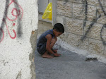 child playing marbles in Aida refugee camp