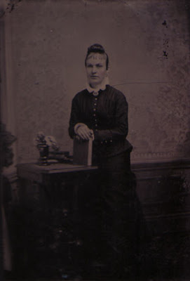 Woman Standing at Table with Book