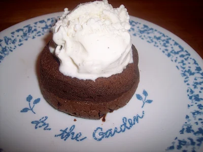 Molten chocolate lava cake topped with vanilla ice cream.