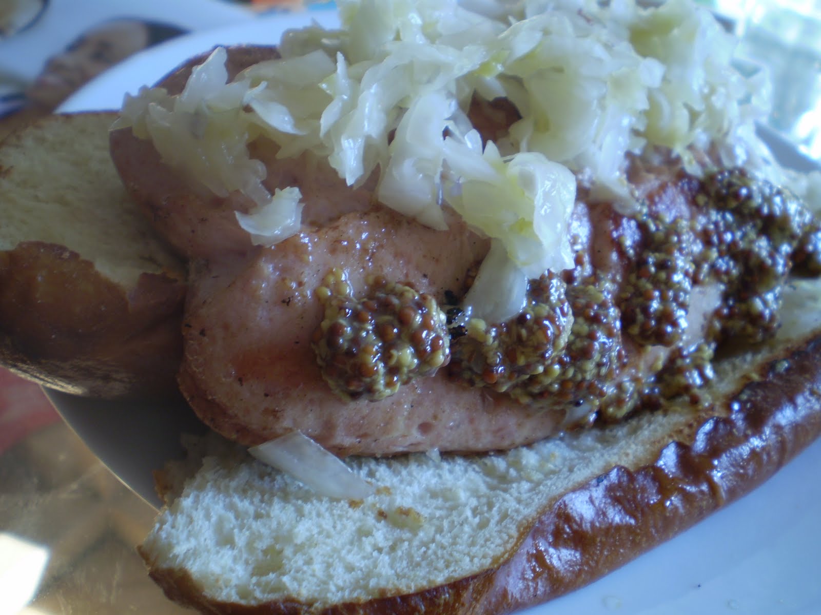 KING BOLETUS Pork and veal hot dog on a pretzel roll with sauerkraut