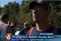 This is a picture of a firefighter who stood by and watched a citizen's home burn to the ground