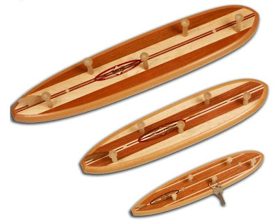 three surfboard shaped peg racks