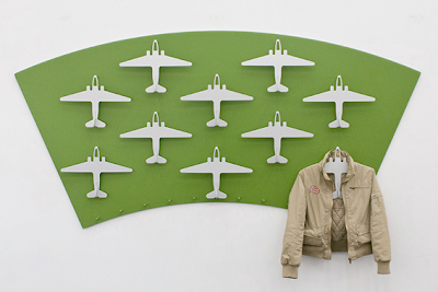 airplane-shaped hangers, on the wall