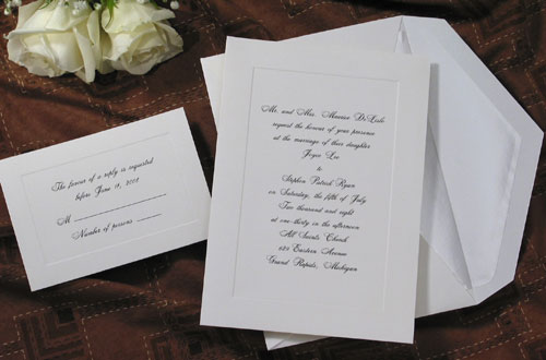 A beautiful unadorned panel is embossed in a soft white vellum invitation